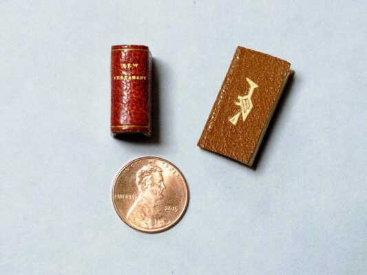 Rare-Books-Naitonal-Library-Week-cMUMMA-600x400 Two miniature books, The New Testament and Bird Word, compared with a penny to demonstrate the book's tiny size.